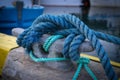 Rope securing boat to wharf. Knot securing fishing boat.