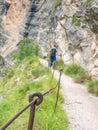 Rope and shackles anchored in hard dolomite limestone rock. Climbers path via ferrata Royalty Free Stock Photo