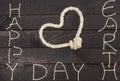 Rope in shape of love heart with text: Happy Earth Day Royalty Free Stock Photo