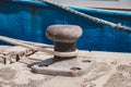 Rope of a ship or boat moored to a bollard at harbor closeup Royalty Free Stock Photo