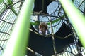 Rope slide for small children. A little boy climbs up the ropes. Child boy climbed on top of the rope web on playground.