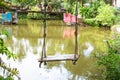 Rope swing next to a lake, concept of tranquility. Royalty Free Stock Photo