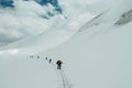 Rope team alpinists on the glacier at high altitude snow mountains
