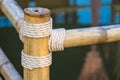 Rope tied knot at bamboo wood Royalty Free Stock Photo