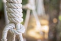 Rope tied in a knot, hanging from a wooden chair