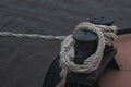 A rope tied to a pier and tied with a sea knot. A ship moored to a pier with a rope Royalty Free Stock Photo