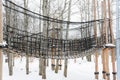 Rope town. Rope road suspended from trees and logs. Winter landscape.