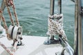 Rope on a yacht. Yacht rope cleat and sunlight. Sailboat winch and rope yacht detail. Yachting Royalty Free Stock Photo