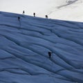 roped climbers on glacier with crevasses