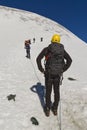 Roped mountaineers traveling on glacier in Austrian Alps