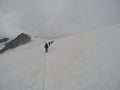 Roped party going up a glacier