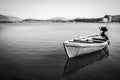 Roped wooden fisher boat in the lake in black and white