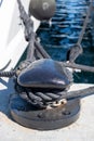 Ropes on black mooring bollard, marina Floisvou, Greece. Vertical Royalty Free Stock Photo