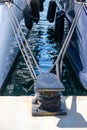 Ropes on black mooring bollard, marina Floisvou, Greece. Vertical Royalty Free Stock Photo