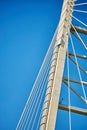 Ropes of a cable-stayed bridge against a blue sky Royalty Free Stock Photo