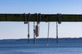 ropes chains and bouys hanging on a wooden beam