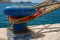 Ropes secured in a blue mooring bollard Royalty Free Stock Photo