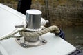Ropes tied around a cleat or bollard on a small boat in a harbour Royalty Free Stock Photo