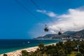 Ropeway cabin on the background of sea, palms and clouds Royalty Free Stock Photo