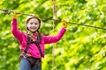Roping park. Portrait of a beautiful kid on a rope park among trees. Happy Little child climbing a tree. Child. Safe Royalty Free Stock Photo