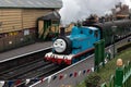 A thomas the tank engine steam train with steam coming out of the funnel