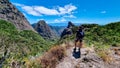 Roque Agando- Man with backpack watching volcanic rock formations in Garajonay National Park seen from Roque de Agando, La Gomera