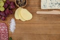 Roquefort cheese, grapes and ham with various ingredients on chopping board Royalty Free Stock Photo