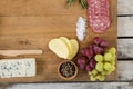 Roquefort cheese, grapes and ham with various ingredients on chopping board Royalty Free Stock Photo