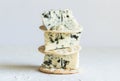 Roquefort cheese wedges on crackers on white background