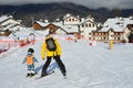 Rosa Khutor, Sochi, Russia, January, 26, 2018. The instructor teaching little boy to go skiing on the child`s training slope in th