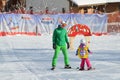 Rosa Khutor, Sochi, Russia, January, 26, 2018. The instructor teaching little girl to ski on the child`s training slope in the bac