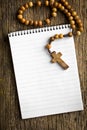 Rosary beads and blank notebook