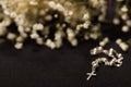 Rosary beads with blurred white small flowers, black background Royalty Free Stock Photo