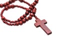 rosary beads with cross made of red wood isolated on a white background, close up with selected focus on christ Royalty Free Stock Photo