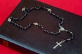 Rosary Beads and Crucifix on Closed Bible Royalty Free Stock Photo