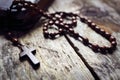 Rosary beads and crucifix cross on holy bible Royalty Free Stock Photo