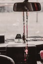 Rosary beads hanging in the mirror in the car Royalty Free Stock Photo