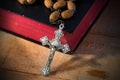 Rosary Beads and Holy Bible on Wooden Table