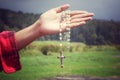 Rosary beads with Jesus Christ holy cross crucifix in young woman hand. Catholic religion symbol. Royalty Free Stock Photo