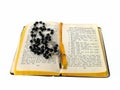 Rosary beads open bible