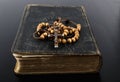 Rosary beads and prayer book on dark background Royalty Free Stock Photo