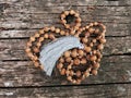 Rosary beads on the wooden background. Rudraksha Mala for Mantras. 108 beads.