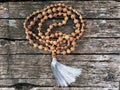 Rosary beads on the wooden background. Rudraksha Mala for Mantras. 108 beads.