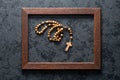 Rosary beads in wooden frame Royalty Free Stock Photo