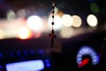Rosary with cross focused and hanging from center mirror inside the car, rest keeping everything defocused Royalty Free Stock Photo