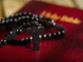 Rosary and cross on the Holy Bible. Minimalism. There are no people in the photo. Spirituality, religion, catholicism, faith,