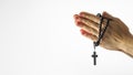 Rosary and crucifix in female hands on a white background. Hands folded for prayer. Religion, Catholicism, prayer, faith,