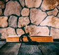 Rosary with a crucifix on an open old book on old wooden table on a background of stone walls Royalty Free Stock Photo