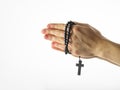 Rosary and crucifixion in female hands. Simple white background. There is an empty space for insertion. Religion, Christianity,