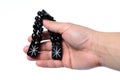 Rosary in hand on a white background isolated Royalty Free Stock Photo